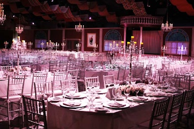 To create the ambience of an early-1900s cruise ship dining room, decorators used crisp white linens and silver accents for a very formal look.