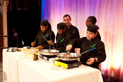Students from the culinary program at Harry S. Truman High School led a cooking demonstration onstage. The two-minute food preparation showcased what was revealed to be the evening's main course.