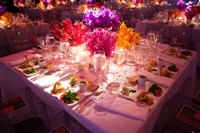 Tables held hundreds of bright orchids in square white vessels.