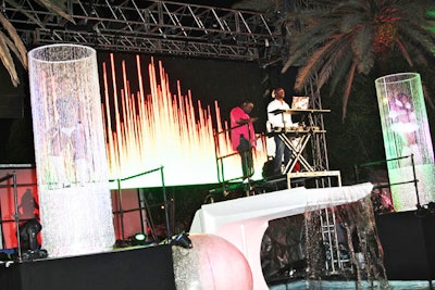 On either side of the DJ, dancers performed on small platforms inside cylindrical beaded curtains.