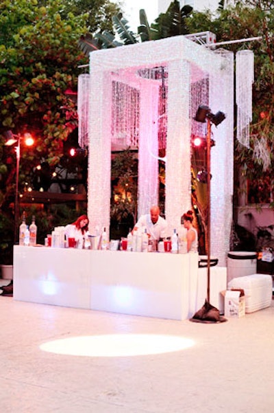 The largest Grey Goose bar included a truss system decorated with crystals and LED lighting. Suspended from the truss was a swing where an acrobat performed throughout the party.