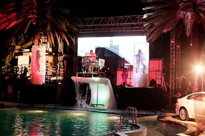 The DJ booth was set on top of the pool's diving board, with water cascading down from it.