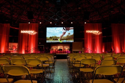 Ceiling-to-floor drapes separated the stage from the post-presentation reception space.