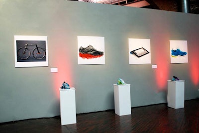 An art exhibit around the perimeter of the space incorporated Saucony sneakers and minimalist art.