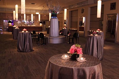 The evening began with a cocktail reception in the grand foyer, where metallic silver tablecloths set the event's color scheme and crystal chandelier drops hung from the ceiling.