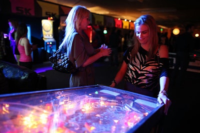 An arcade area featured a pinball machine, air hockey table, and classic games like Pac-Man.