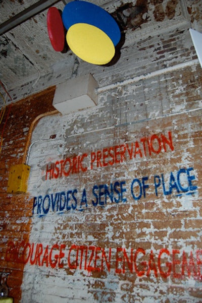 Planners spray painted the 12 ways historic preservation helps build cities on the walls of the factory.