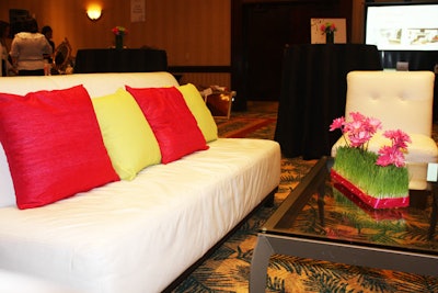 Unique Option provided white lounge furniture accented with pillows in fuchsia and lime, the event's signature colors.