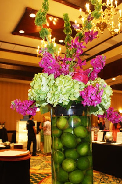 Lee James Floral Designs produced all of the arrangements for the event, including four large vases filled with limes and topped with roses, hydrangea, stock, and orchids. Each of the arrangements was sold in the silent auction.