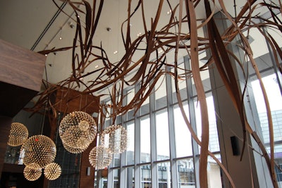 A walnut ceiling installation by artist Dennis Lin spans the length of the restaurant.