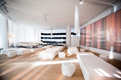 The mod setting was designed to complement the venue's architecture, with black and white curved furniture contrasted by linear white suede ottomans of varying heights.