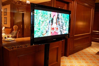 At each end of the tearoom, flat-screen TVs broadcast the ceremony.