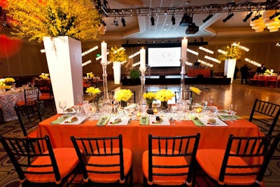 Orange linens and springy flowers, including daffodils, ranunculus, and tulips played into the decor.