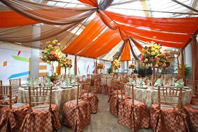 A Vista Events used cream, burnt orange, and tan draping to create a canopy above the dining area in the center of the third floor.