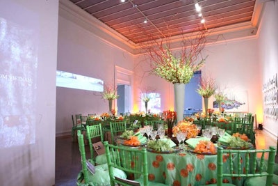 The Hawaiian-themed gallery on the second floor had lime green and orange linens, leis on the place settings, and flowers in the center of each table.