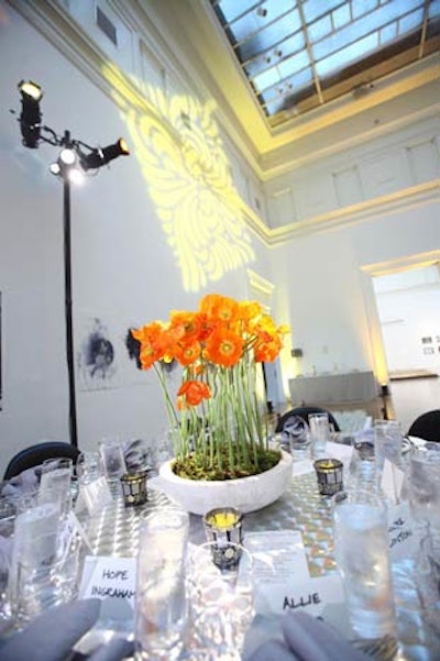 Simple floral arrangements of orange daisies in white ceramic bowls adorned the tables of the staff dining room.