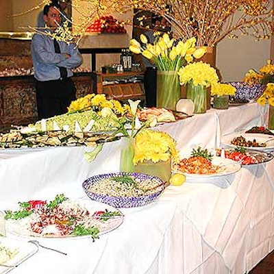 The buffet spread for the Citymeals-on-Wheels' Corporate Dineout reception at Estiatorio Milos was decorated with sunflowers, daffodils, calla lilies and yellow tulips and gerbera daisies by Flowers of the World.