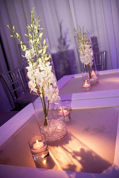 At the Friday night party, the decor was clean and simple, with touches like white dendrobium orchids in cylinders with glass beads at the base, flanked by candles.