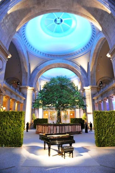 Rising from a moss-trimmed plinth in the center of the great hall was a 30-foot-tall faux English oak tree inspired by the landscape of Alexander McQueen’s property in Sussex, England, and a replica of the mythical 'Tree of Life.' The enormous hardwood arrived from California in 300 pieces and required 16 hours to erect.