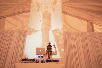 For the DJ backdrop, Wagner employed floor-to-ceiling white muslin that projected imagery from the 9 a.m. fashion show. She used video mapping to make the images appear to 'rain' down the muslin.