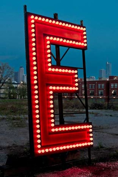 In the set design for The Hot L Baltimore, the 'E' in the hotel's name is missing. Event Creative designers placed an oversize version of the missing letter in a lot across from the after-party venue.