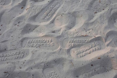 As the night wore on, the sand was filled with the imprint of the American Express logo from the flip-flops.