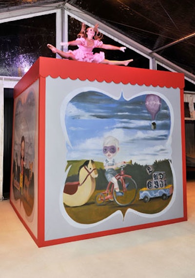 From inside the giant jack-in-the-box, three performers emerged, each dressed as a different children's toy.