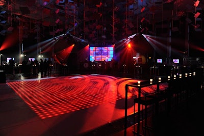 The LED dance floor was bordered by simple black tables and stools.