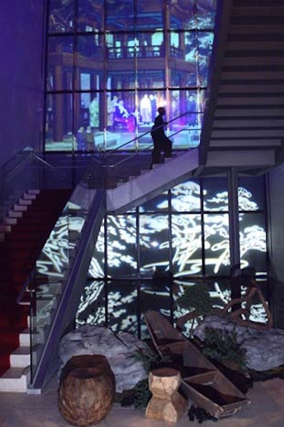 At the sound of a gong at the end of the third and final laser show, guests descended a red carpeted staircase, passing a garden with bonsai trees and rock formations on the way to the ballroom.