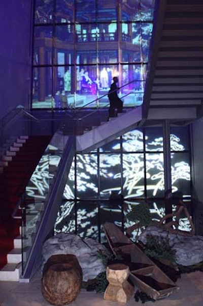 At the sound of a gong at the end of the third and final laser show, guests descended a red carpeted staircase, passing a garden with bonsai trees and rock formations on the way to the ballroom.