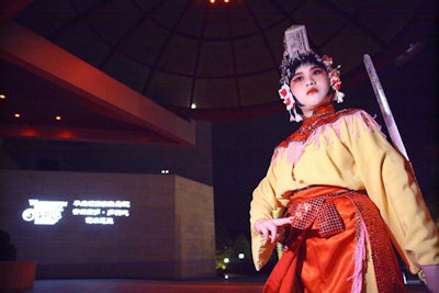 Members of the Washington-based Peking Opera Workshop dressed in traditional costume served as greeters outside the chancery building, as guests arrived at 9:30 p.m. after attending formal dinners at 30 embassies around the city.