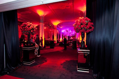 Frost handled lighting, and Kehoe Designs brought in towering arrangements of deep red roses.