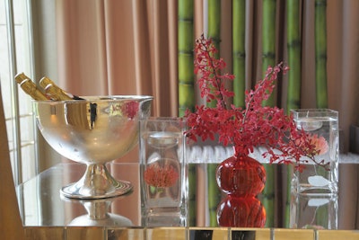 Red flowers and floating votive candles topped the mirrored bar.