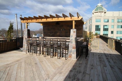 Arlington Rooftop Bar and Grill's namesake space has a slate bar at the center of the rooftop with movable bar stools.