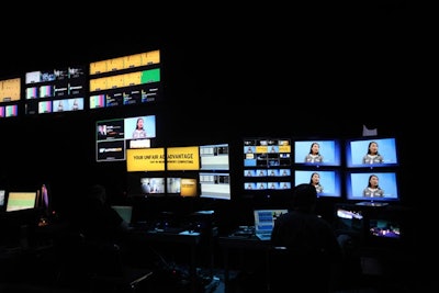 The broadcast center, a glass-walled room set up on the show floor, served as the nucleus of the satellite and online content dissemination.