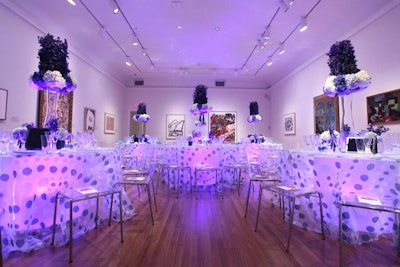 One of the galleries hosting dinner had a blue and white theme with illuminated tables and sheer polka-dot linens.