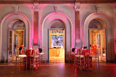 Pink lighting in the main ballroom of the Anderson House accented the pink and orange linens on the cocktail tables.