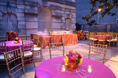 Organizers set up tables draped in pink and orange linens and accented by gold chairs on the back patio of the after-party.