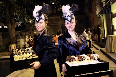 Vintage-dressed cigarette girls served cookies and chocolate pops from their trays at the after-party.