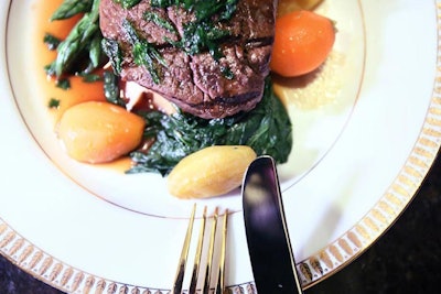 Occasions Caterers served a three-course dinner with a main entrée of steak with sautéed spinach and vegetables.