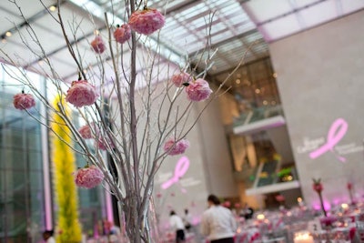 Centerpieces included glass vases filled with branches and hanging pink peonies by Columbine Custom Floral Design.
