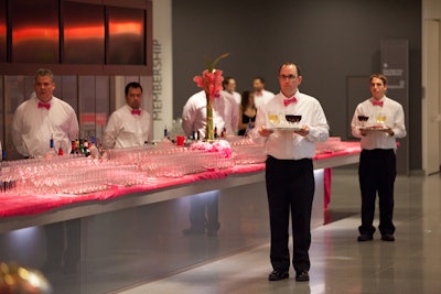 Servers passed wine from a pink bar during the cocktail hour.