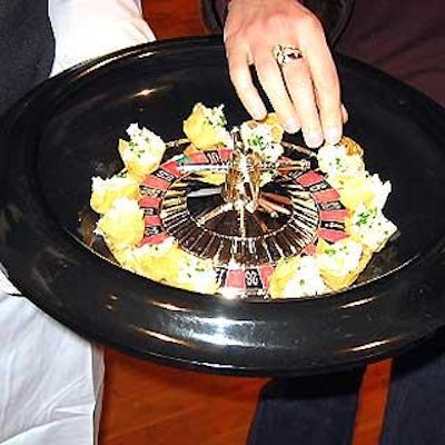 Olivier Cheng Catering & Events served hors d'oeuvres from customized trays including one made from a small roulette wheel.