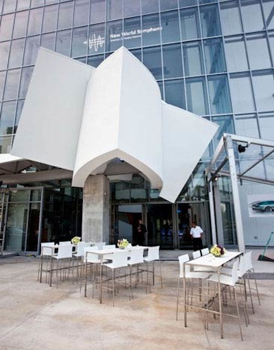 White high-top tables and chairs blended with the white architectural features of the building.
