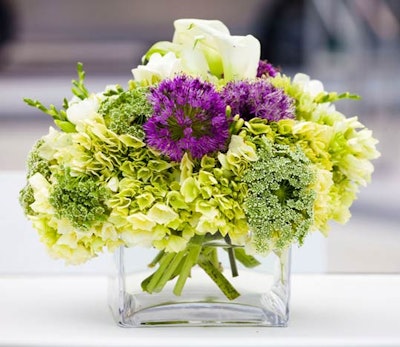 Flower Bazaar created simple centerpieces of green hydrangea, allium, white mini calla lilies, and queen lace.