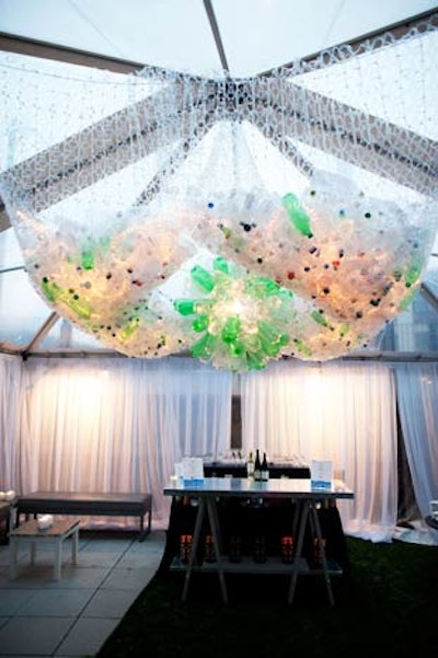 Trash-turned-art hung overhead in an indoor-outdoor seating area.