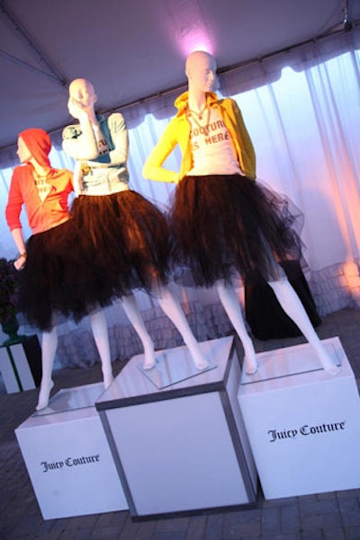 Mannequins in the white outdoor tent rested on Juicy Couture-branded white cubes.