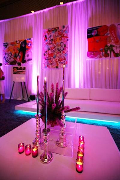 In one of the lounges, Mystique Flowers created centerpieces using liatris and pincushion proteas in acrylic square containers flanked by silver taper candles and purple votives.