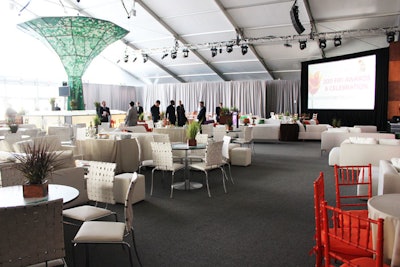 Inside the Tent at Lincoln Center, Dalzell Productions used mostly white furniture to fill the lounge spaces and seating areas for the guests. In a nod to the location, the producers juxtaposed leafy greenery and a modern architectural aesthetic in the two bars that anchored the site.