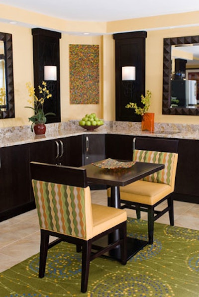 Hughes Design Associated used a new palette of green, orange, and yellow complemented by dark wood furnishings throughout the hotel, beginning with the concierge lounge.